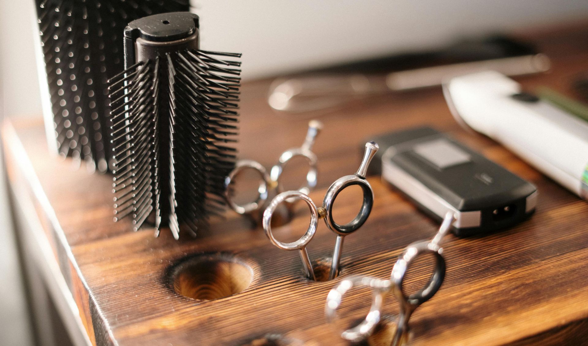 Close-up of barber tools on a stylish wooden counter, perfect for a salon setting.