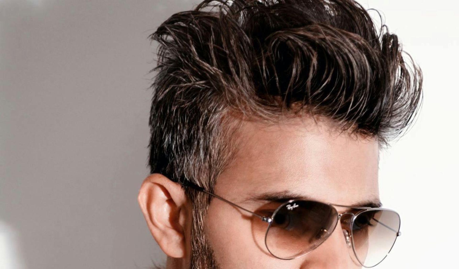 Fashion-forward man wearing a fur coat and sunglasses, exuding style.